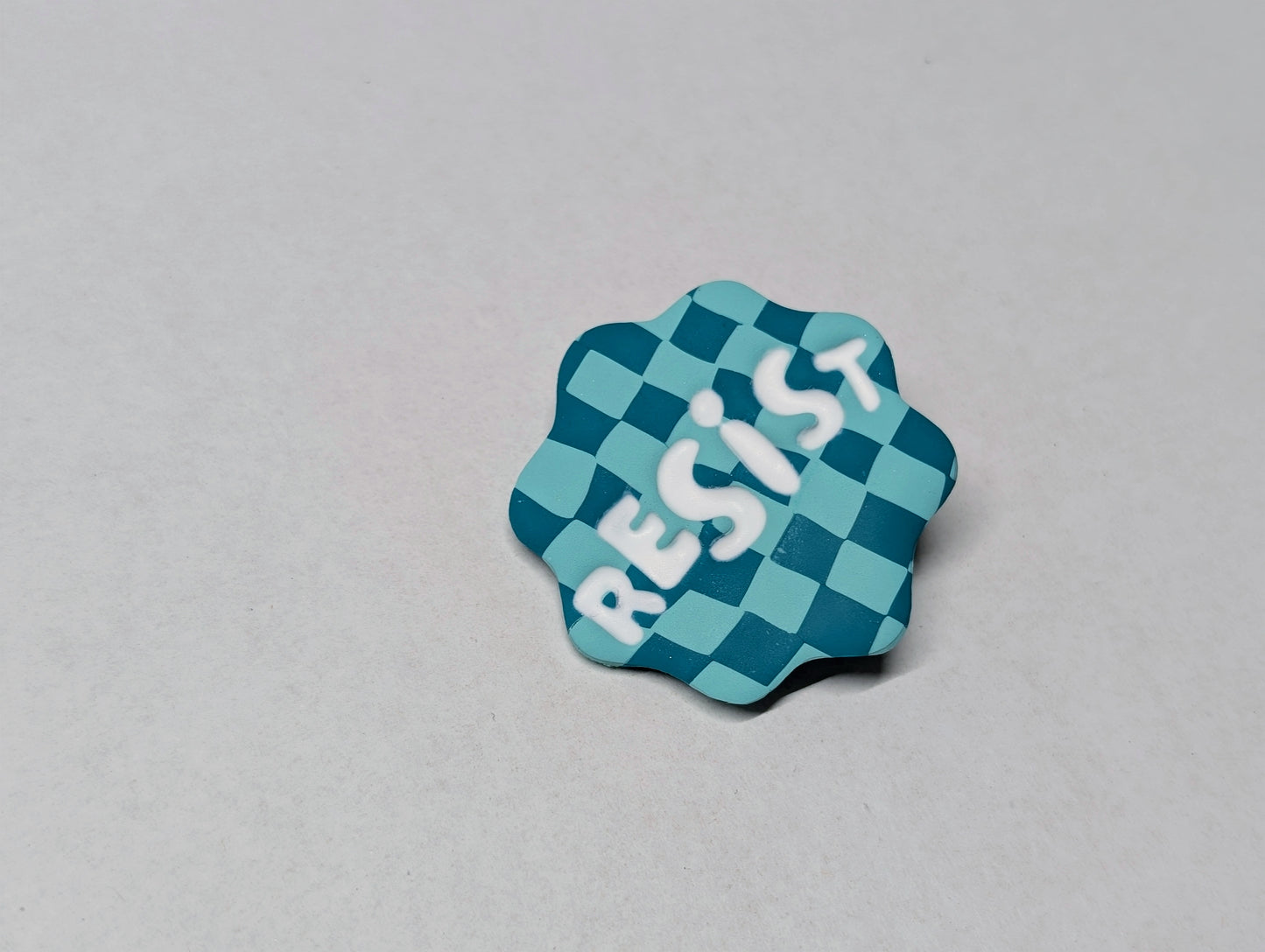 RESIST Pin - Teal Checks