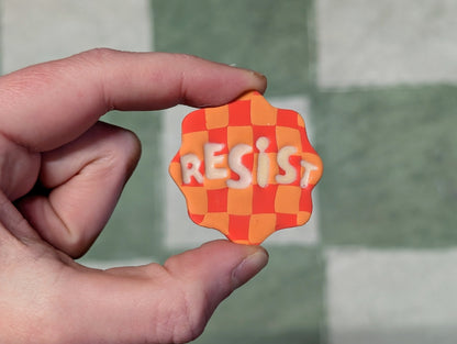 RESIST Pin - Orange Checks